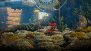 Unravel: Yarny hält einen Knopf